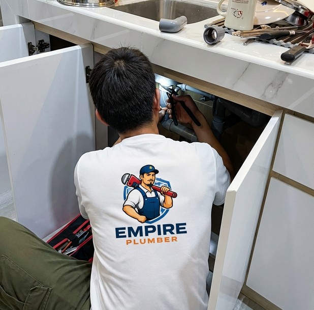 Empire Plumber fixing kitchen sink plumbing